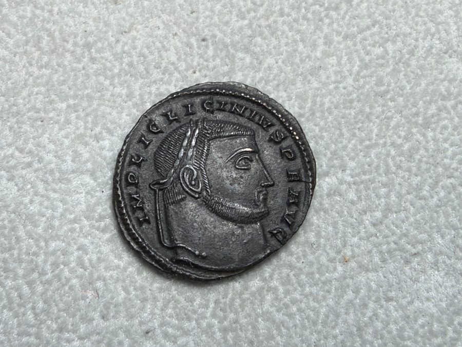 Photo of the obverse of a Licinius I follis on grey cloth